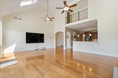 Unfurnished living room featuring high vaulted cei