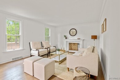 Living room featuring a fireplace, light hardwood