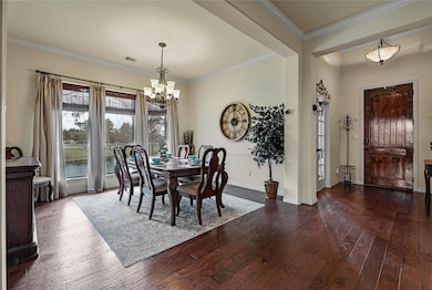 The formal dining room is perfect for hosting dinner parties with family and friends. Recent lighting updates and crown molding additions.