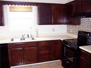 Kitchen. Kitchen has cherry stained cabinets and a