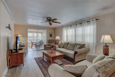 Living room with crown molding, a textured ceiling