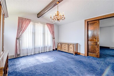 The living room and dining room are separated by a working pocket door