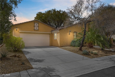View of front of home featuring stucco siding, dri