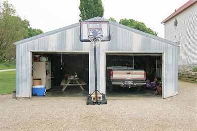 This detached garage holds a Truck, has a concrete