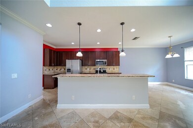 Kitchen with hanging light fixtures, tasteful backsplash, and appliances with stainless steel finishes