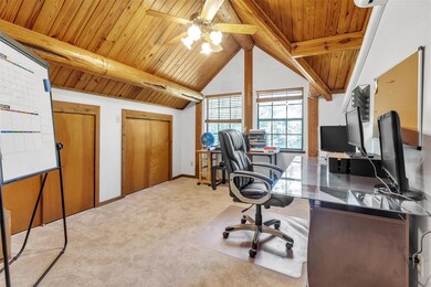 Office area with light carpet, wood ceiling, and 