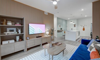 Living room with a ceiling fan, light wood-type f