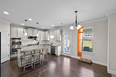Kitchen featuring crown molding, appliances with s