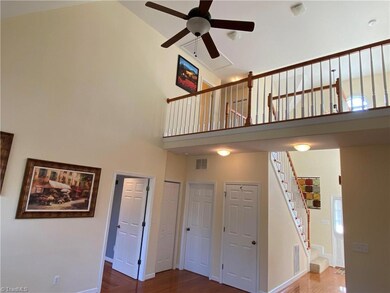 Vaulted ceiling in den, with overlook from loft area upstairs.