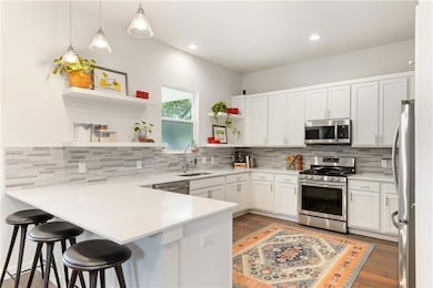 Kitchen featuring stainless steel appliances, ope