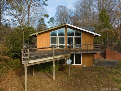Back of property featuring a wooden deck