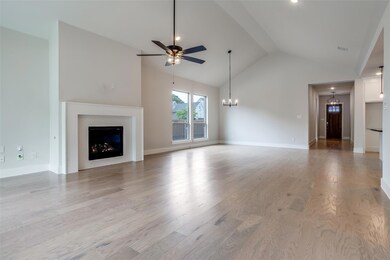 Unfurnished living room featuring ceiling fan with
