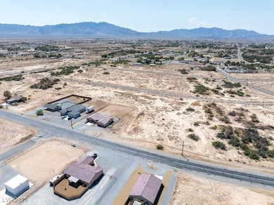 Overview of rural landscape featuring mountains and nearby suburban area