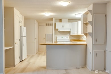 Let’s step into the kitchen! New vinyl plank flooring adds style and durability.