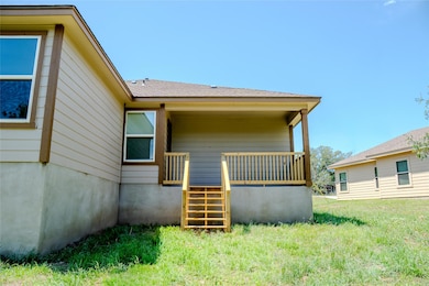 Rear view of property featuring a lawn