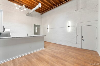 Below grade area featuring brick wall, light wood-