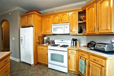 Open Bright Kitchen with Warm Cabinetry; Crown Mol