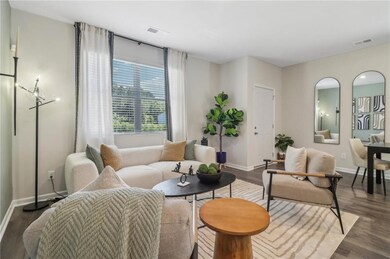 Living room featuring baseboards and dark wood-style flooring