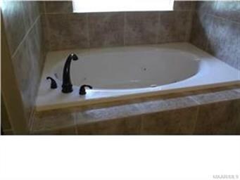 Also the master bath has a jetted tub and tile sur