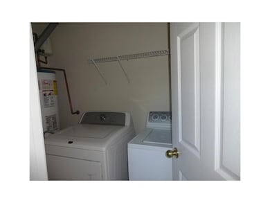 Laundry area with gas water heater and independent washer and dryer