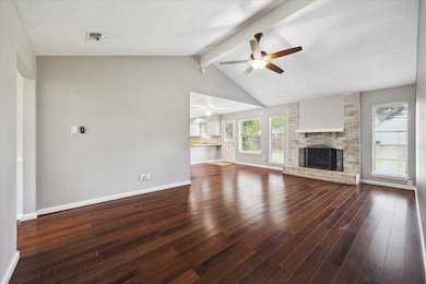 Wood floors and a bricked wood burning fireplace h