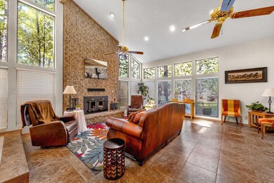 Tiled living room featuring a large fireplace, cei