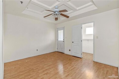 Spare room featuring ceiling fan, light wood-style flooring, beam ceiling, and coffered ceiling