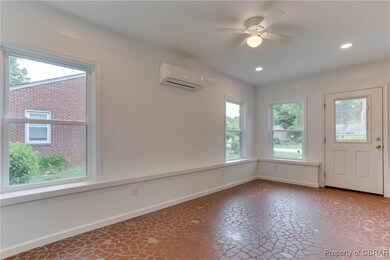 Foyer entrance with an AC wall unit, baseboards, r