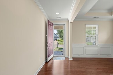 Foyer with hardwood / wood-style floors and orname