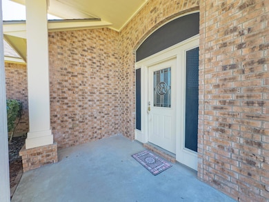 View of exterior entry with brick siding