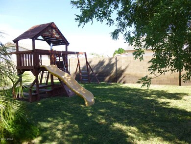 Swing set in Backyard and Grassy Area