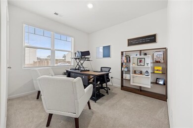 Carpeted home office featuring baseboards