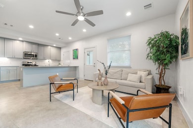 Living room featuring concrete flooring, recessed