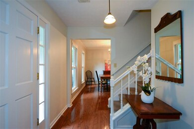Foyer entrance featuring wood finished floors and stairway