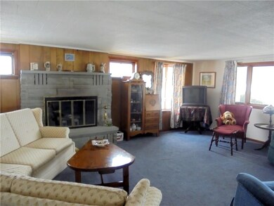 Living room with wood burning fireplace.