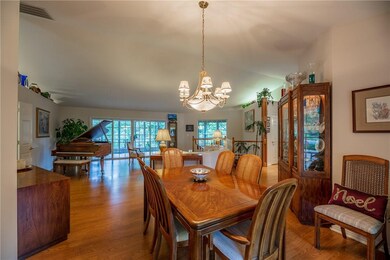 Formal dining area.  Note expansive window wall leading to glass enclosed 3-season porch.