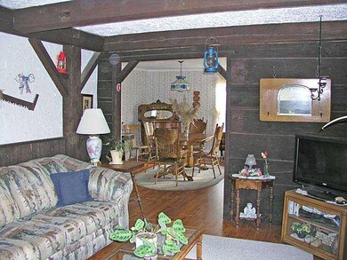 Living Room. Rustic paneling, beamed ceilings add 