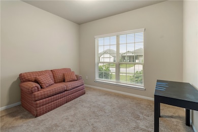 Living area featuring baseboards and carpet floori