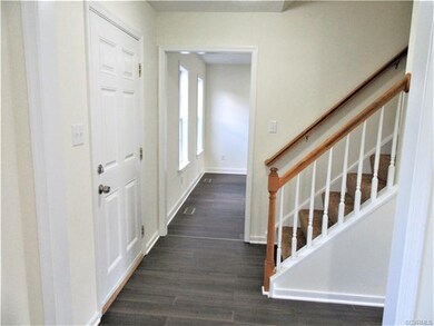 The Foyer features Bamboo Flooring, Neutral Paint Palette, Convenient Coat Closet, Large Entry to the Formal Dining Room, and the Stairs to the 2nd Floor!