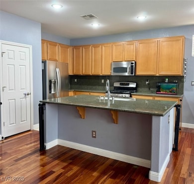 Kitchen featuring dark wood-style flooring, applia