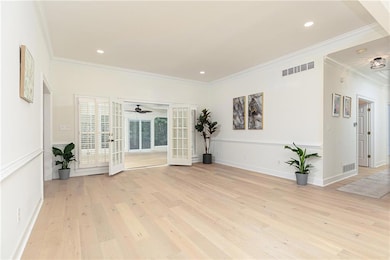 Unfurnished room featuring ceiling fan, crown mold