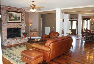 Living area is open to the dining room, kitchen and breakfast area. Beautiful distressed hardwood floors throughout the main level of the house. 