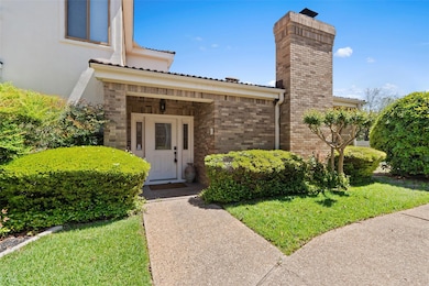 Property entrance featuring brick siding, a tiled