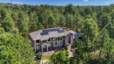 View from above of property featuring a heavily wooded area