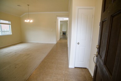 Formal living and dining room, another view.  Note coat closet near front door.