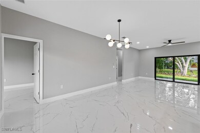 Empty room featuring marble tiled floors, baseboar