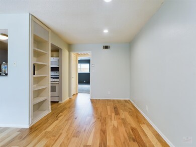 Empty room featuring baseboards, visible vents, l