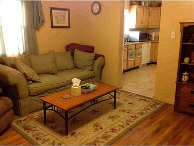 Living Room. Hard-wood flooring highlights the liv