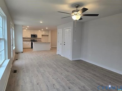 Unfurnished living room featuring light wood-style floors, recessed lighting, and a ceiling fan