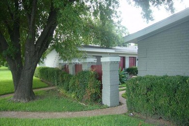 View of property exterior with brick siding